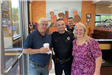 Two officers at Dunkin Donuts with two citizens
