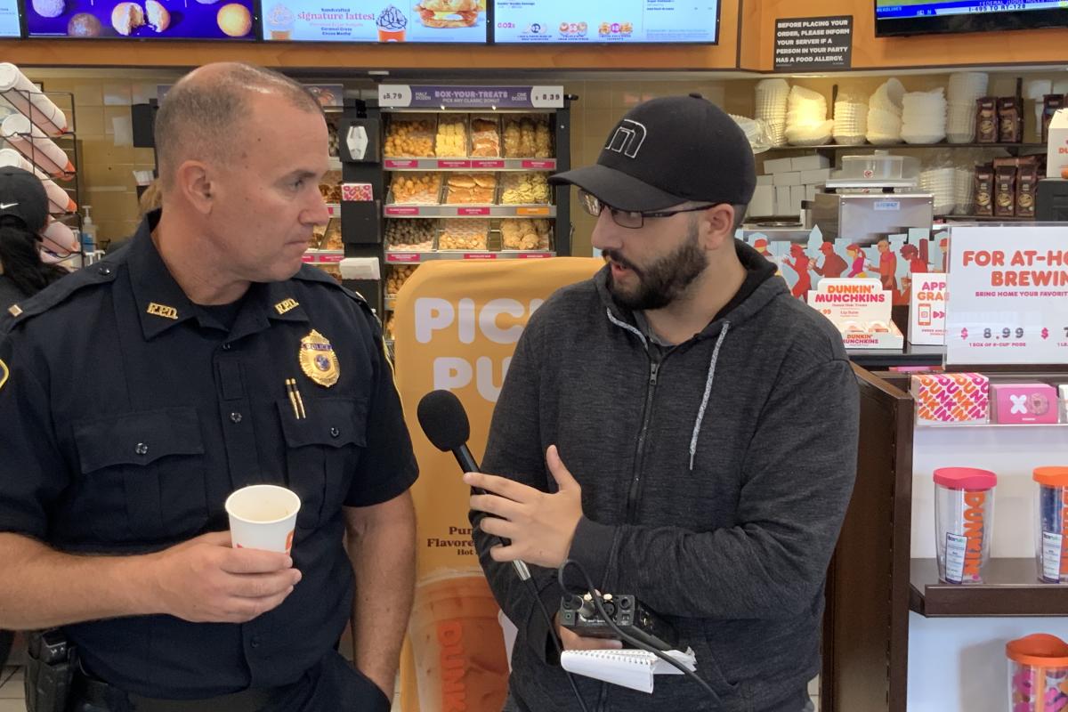 Officer at Coffee with Cops being interviewed