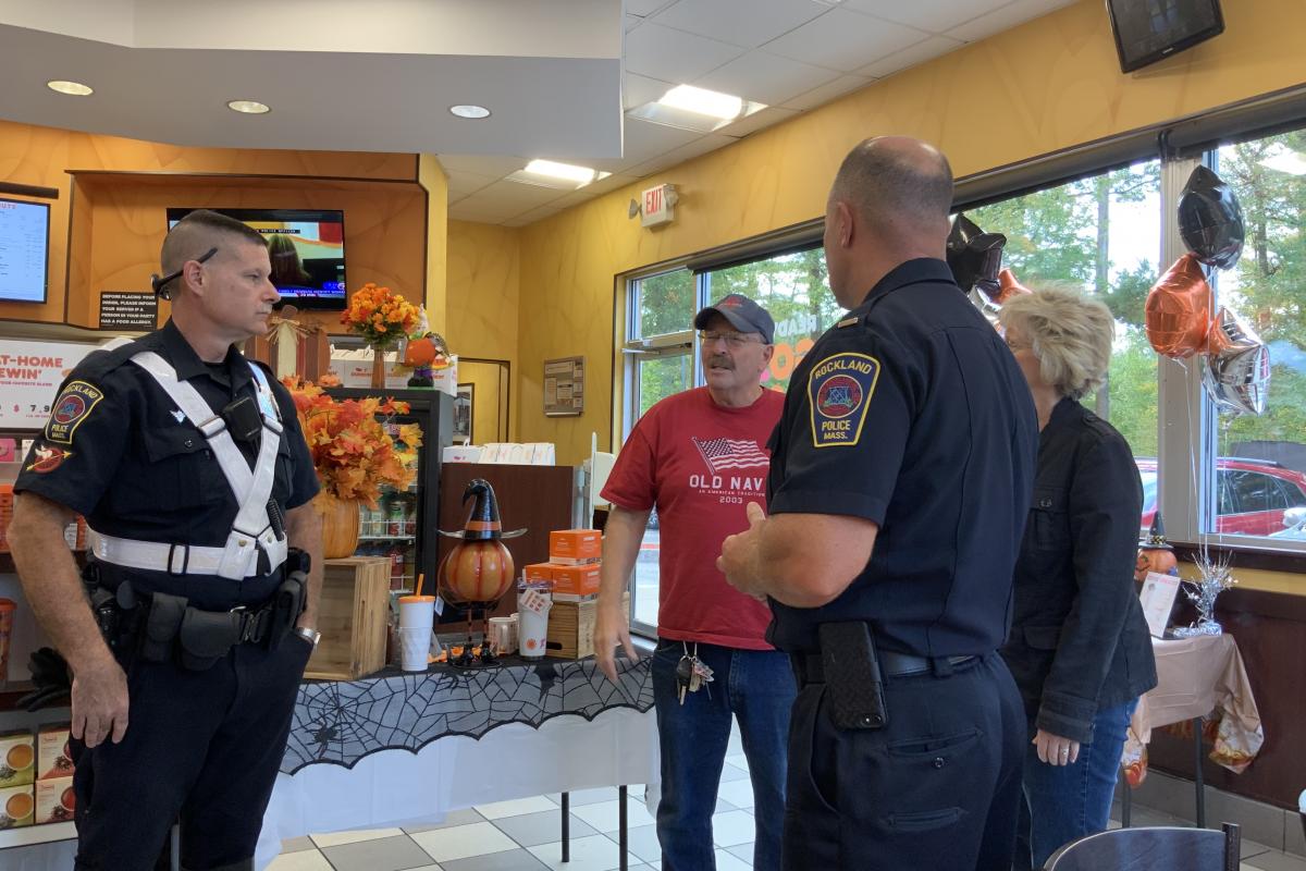 Man and Woman Speaking with Two Officers